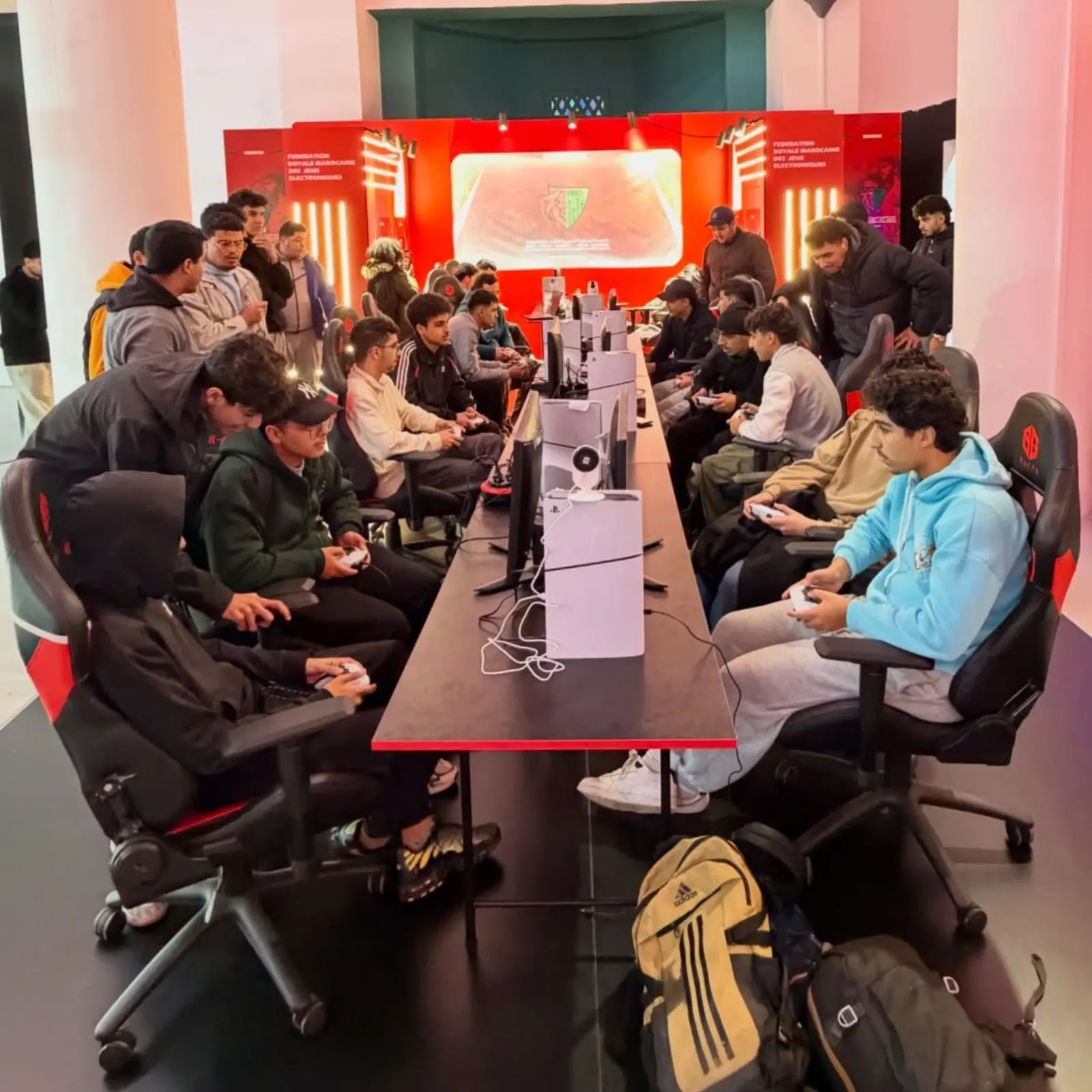 FRMJE stand within the eZone Fanzone in Casablanca during AFCON 2025, with esports players competing on consoles and PCs, attracting a large audience in a dedicated gaming area
